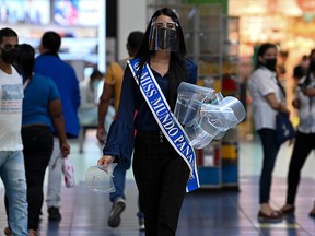 Miss World Panama 2021, Krysthelle Barretto, gives out face shields as part of a campaign by the Ministry of Health (MINSA) to distribute some 2,000 face screens as a measure to slow the spread of COVID-19, in Panama City on February 1, 2021.