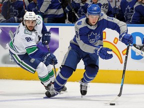 Jalen Chatfield of the Vancouver Canucks chases after Mitchell Marner of the Toronto Maple Leafs at Scotiabank Arena on February 6, 2021 in Toronto.