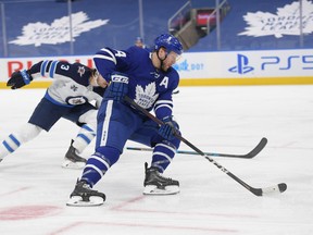 Maple Leafs defenceman Morgan Rielly (44) carries the puck in a game against the Winnipeg Jets on March 11. With the Leafs idle until Thursday, Rielly acknowledged getting antsy as the rest of the North Division teams go about their business.