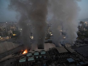 Smoke billows after a fire broke out at a hospital in Mumbai, India, March 26, 2021.