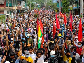 This handout photo taken and released by Dawei Watch on March 27, 2021 shows protesters making the three-finger salute during a demonstration against the military coup in Dawei.