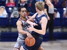 Gonzaga Bulldogs guard Andrew Nembhard (left) has helped his team to an unbeaten record as the March Madness tournament is set to begin. USA TODAY SPORTS