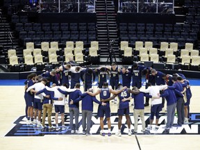 Oral Roberts players pray after their big win over Ohio State.