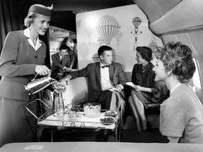A Pan Am stewardess serves some first-class guests aboard a Boeing 707. THE CANADIAN PRESS
