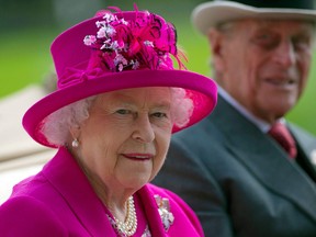 In this file photo Queen Elizabeth II and her husband Prince Philip, Duke of Edinburgh arrive on the fourth day of the annual Royal Ascot horse racing event near at Ascot, west of London, on June 20, 2014.