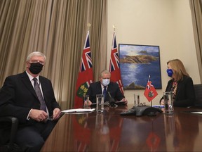 Retired General Rick Hillier, chair of the COVID-19 Vaccine Distribution Task force (L-R), Ontario Premier Doug Ford, Health Minister Christine Elliott and Solicitor General Sylvia Jones on a conference call at Queens Park on February 26, 2021.