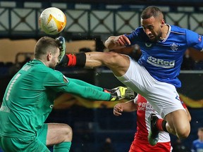 Rangers' striker Kemar Roofe challenges Slavia Prague's goalkeeper Ondrej Kolar during the UEFA Europa League match at the Ibrox Stadium in Glasgow on March 18, 2021.