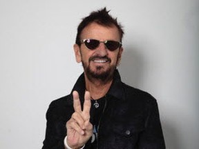 Beatles drummer Ringo Starr, 80, flashes the peace sign.