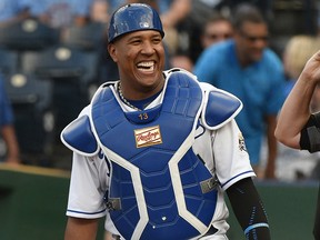 Salvador Perez of the Kansas City Royals laughs as he prepares to catch against the Chicago Cubs at Kauffman Stadium on August 7, 2018 in Kansas City.