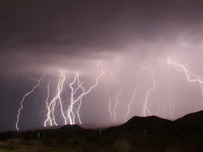 Mass lightning bolts, taken using a long exposure, light up the night sky from monsoon storms passing over the high deserts, north of Barstow, Calif., July 1, 2015.