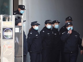 Police officers stand guard at a side entrance of the Intermediate People's Court where Michael Spavor, a Canadian detained by China in December 2018 on suspicion of espionage, is expected to stand trial, in Dandong, Liaoning province, China March 19, 2021.