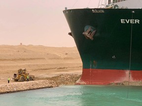 A handout picture released by the Suez Canal Authority on March 24, 2021 shows a part of the Taiwan-owned MV Ever Given (Evergreen) lodged sideways and impeding all traffic across the waterway of Egypt's Suez Canal.