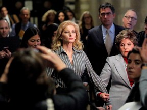 Summer Zervos, a former contestant on The Apprentice, centre, leaves New York State Supreme Court with attorney Gloria Allred, right, after a hearing on the defamation case against U.S. President Donald Trump in Manhattan, New York City, Dec. 5, 2017.