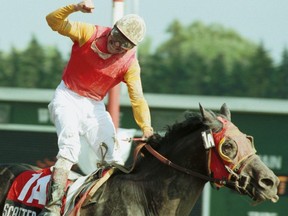 Scatter The Gold, under jockey Todd Kabel, captures the 141st running of the Queen's Plate Stakes at Woodbine in 2000.