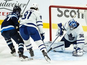 Toronto Maple Leafs goaltender Jack Campbell blocks a shot by Winnipeg Jets forward Nikolaj Ehlers on March 31, 2021, in Winnipeg.