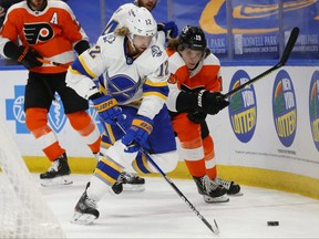 Buffalo Sabres forward Eric Staal (12) works for the puck during a game against the Philadelphia Flyers on Feb. 28. Why does Staal, traded from Buffalo to Montreal, only have to do a seven-day quarantine while ordinary Canadians still have to do 14?