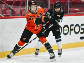 Emma Woods (left) moves the puck for the Toronto Six during a recent National Women's Hockey League game at Herb Brooks Arena in Lake Placid, New York. SUBMITTED