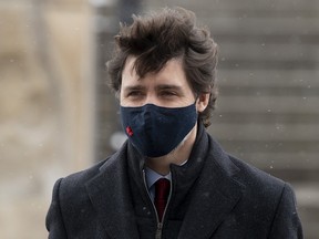 Prime Minister Justin Trudeau makes his way to a news conference in Ottawa, Friday, Feb. 19, 2021.