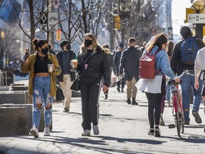 Pedestrians along Bloor St. W. In the Yorkville area in Toronto, Ont.  on Tuesday March 9, 2021