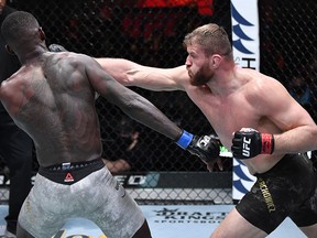In this handout image provided by UFC,  Jan Blachowicz punches Israel Adesanya in their UFC light heavyweight championship fight during UFC 259 at UFC APEX on March 6, 2021 in Las Vegas.