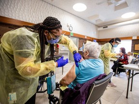 Nurse Tahani McDonald from Humber River Hospital administers the Moderna COVID-19 vaccine at a Toronto Community Housing seniors building in the northwest end of Toronto,  March 25, 2021.