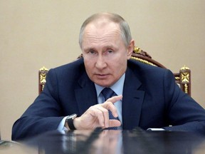 Russian President Vladimir Putin attends a meeting with government members via a video link in Moscow, March 10, 2021.