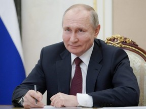 Russian President Vladimir Putin takes part in a meeting with community representatives and residents of Crimea and Sevastopol via a video link in Moscow, Thursday, March 18, 2021.