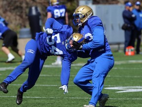 Linebacker Thiadric Hansen (right) takes down LB Manuel Hernandez-Reyes during a special teams drill at  Winnipeg Blue Bombers rookie camp in 2019.