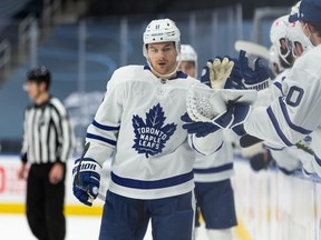 Maple Leafs’ Zach Hyman celebrates with teammates after scoring a goal on Oilers’ goaltender Mikko Koskinen in Edmonton on March 1, 2021.