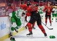 Senators' Austin Watson fights Maple Leafs' Zach Bogosian (left) on Sunday, March 14, 2021 at Canadian Tire Centre in Ottawa.