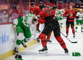 Senators' Austin Watson fights Maple Leafs' Zach Bogosian (left) on Sunday, March 14, 2021 at Canadian Tire Centre in Ottawa.