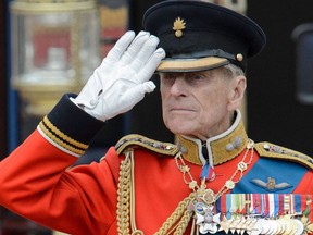 In this file photo taken on June 16, 2012, Britain's Prince Philip, Duke of Edinburgh salutes as he watches the troops ride past outside Buckingham Palace following the Queen's Birthday Parade, 'Trooping the Colour' at Horse Guards Parade in London .