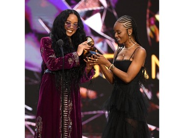 In this handout photo courtesy of The Recording Academy, (L-R) H.E.R. and Tiara Thomas accept the Song of the Year award for 'I Can't Breathe' onstage during the 63rd Annual GRAMMY Awards at Los Angeles Convention Center on March 14, 2021.