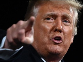 In this file photo former US President Donald Trump points at the end of a rally to support Republican Senate candidates at Valdosta Regional Airport in Valdosta, Georgia on December 5, 2020.