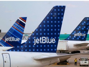 JetBlue Airways aircrafts are pictured at departure gates at John F. Kennedy International Airport in New York June 15, 2013.