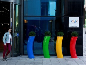 A woman walks past the Google offices near the city centre in Dublin July 8, 2013.