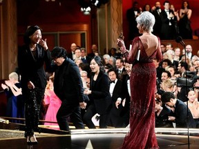 Jane Fonda gives the Best Motion Picture Oscar statue to Kwak Sin Ae and Bong Joon Ho at the 92nd Academy Awards in Hollywood, Los Angeles, California, U.S., February 9, 2020.