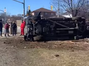 A pickup truck lays on its side after a crash in a residential area of Barrie on Saturday, March 14, 2021.