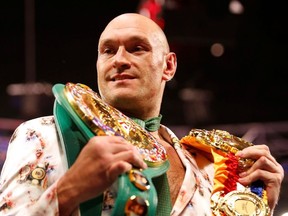 Tyson Fury poses with his belts during a press conference after the fight REUTERS/Steve Marcus/File Photo ORG XMIT: FW1