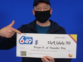 Bryan Hamilton claims his winnings from the Feb. 27, 2021 Lotto 6/49 draw.