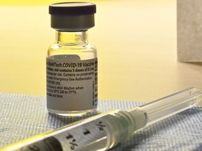 A syringe of the COVID-19 vaccine waits to be administered in Toronto on Monday, Dec. 14, 2020.