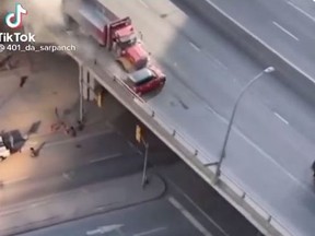 The driver of the dump truck was charged with several driving and commercial motor vehicle offences, Toronto Police said, after video surfaced of the truck crashing into the side of a smaller red vehicle Tuesday morning.