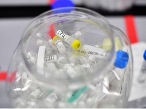 Used vials are seen at a laboratory where they sequence the novel coronavirus genomes at COVID-19 Genomics UK, on the Wellcome Sanger Institute's 55-acre campus south of Cambridge, Britain March 12, 2021.