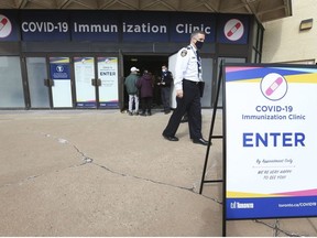 Toronto EMS Commander Mike Wionzek talks to seniors over over 80 as they head into a Toronto City COVID Immunization centres to get the jab at the Scarborough Town Centre. There were two other locations at the Toronto Congress Centre and downtown at the MTCC. Each centre doled out 450 shots, by appointment only, on the day on Wednesday March 17, 2021. Jack Boland/Toronto Sun/Postmedia Network