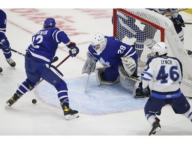 Toronto Marlies Alex Galchenyuk C (12) tries to get the puck out of the crease  in front of teammate Andrew D'Agostini G (29) during the second period in Toronto on Monday March 1, 2021. Jack Boland/Toronto Sun/Postmedia Network