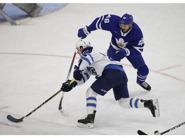 Manitoba Moose Nicholas Jones C (24) is stopped going around Toronto Marlies Calle Rosen D (48) during the third period in Toronto on Monday March 1, 2021. Jack Boland/Toronto Sun/Postmedia Network