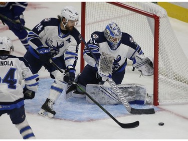 Manitoba Moose Jimmy Oligny D (14) steers the puck past his goalie  Mikhail Berdin G (40) during the third period in Toronto on Monday March 1, 2021. Jack Boland/Toronto Sun/Postmedia Network