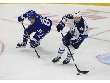 Toronto Marlies Nick Robertson LW (89) chases down Manitoba Moose Ville Heinola D (34) during the first period in Toronto on Monday March 1, 2021. Jack Boland/Toronto Sun/Postmedia Network