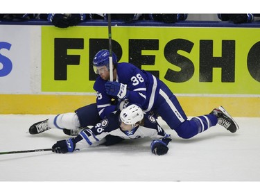 Toronto Marlies Justin Brazeau F (38) lays out Manitoba Moose Brett Davis LW (48) during the first period in Toronto on Monday March 1, 2021. Jack Boland/Toronto Sun/Postmedia Network