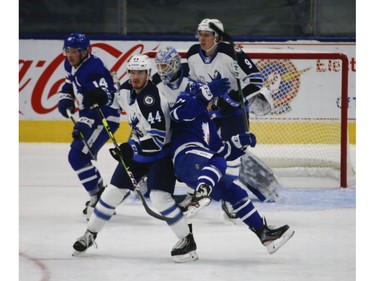 \Manitoba Moose Dylan Samberg D (44) dumps Toronto Marlies Joseph Duszak D (21) in the slot during the second period in Toronto on Monday March 1, 2021. Jack Boland/Toronto Sun/Postmedia Network